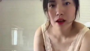 Chinese girl in bathroom stripping
