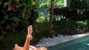 Liya Silver sunbathing naked near the pool